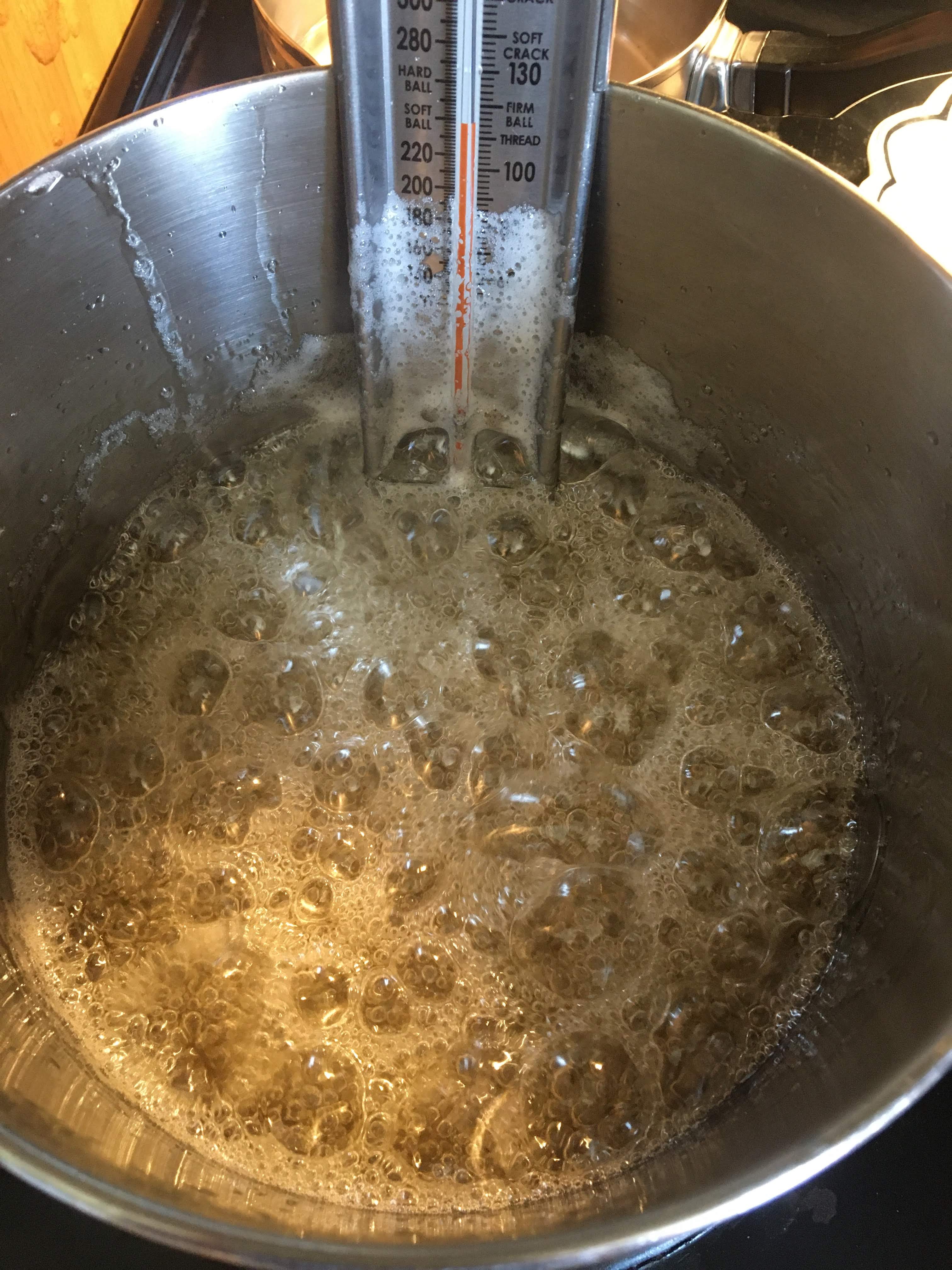 candy thermometer in boiling sugar